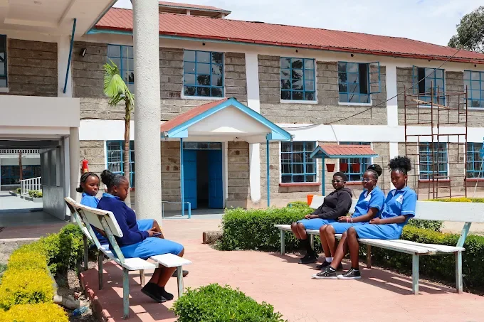 Students relaxing on benches in the campus courtyard