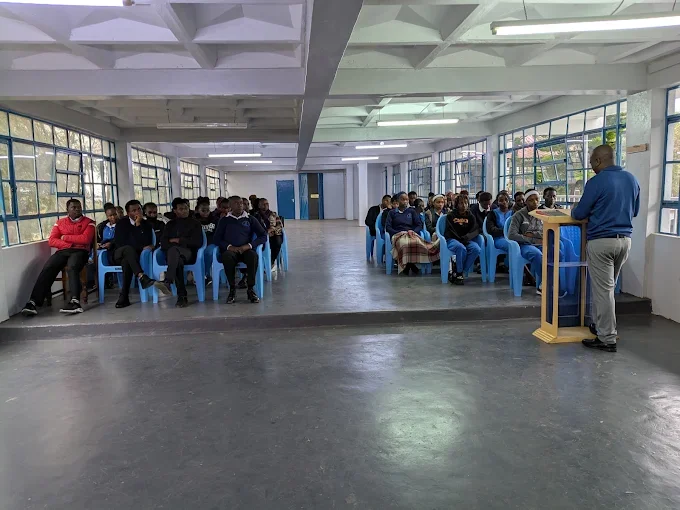 Students listening to a talk in the campus hall
